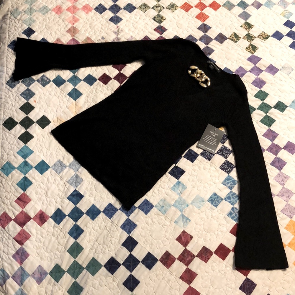 Black V-Neck Sweater with Gold chain accent.
